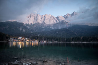 Scenic view of lake and mountains against sky