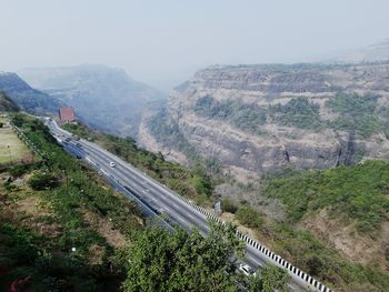 High angle view of road amidst mountains against sky