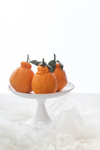 Close-up of orange fruit against white background