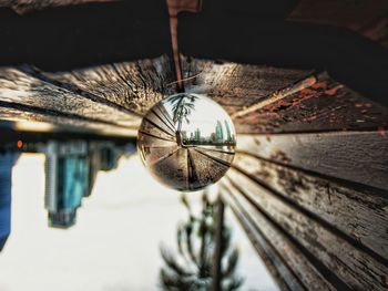 Close-up of crystal ball on wooden bench