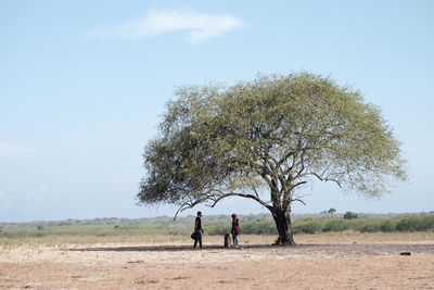 People on field against sky