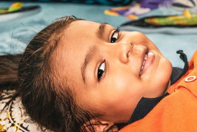Close-up of girl lying on bed
