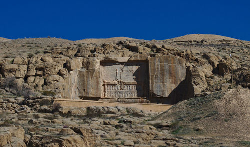 Old ruins in persepolis against blue sky