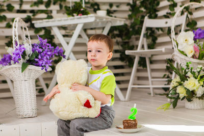 Cute girl sitting with toy toys