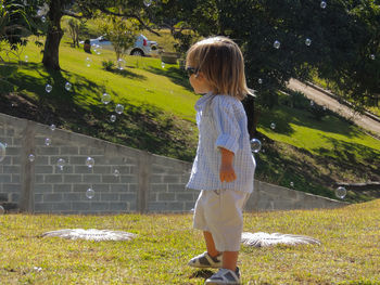 Full length of boy standing on grass