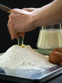 Close-up of hands making a cake