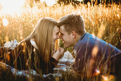 Young couple kissing on field