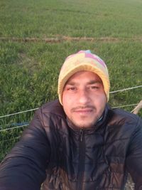 Portrait of mid adult man standing on field