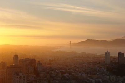 High angle view of buildings in city during sunset