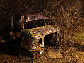 Old abandoned car on field