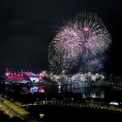 Low angle view of firework display at night