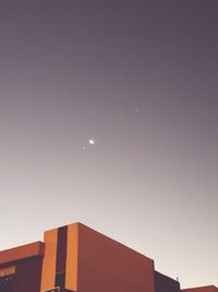 Low angle view of building against clear sky at night