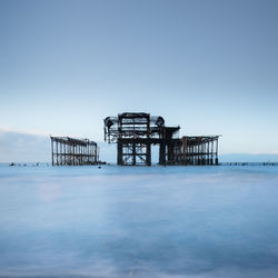 Brighton west pier slow shutter sea with pier and blue sky
