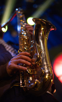 Midsection of person playing lit up at music concert