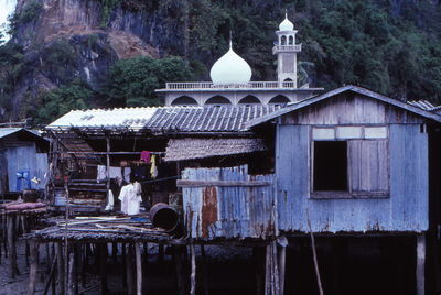 Huts and mosque against mountain