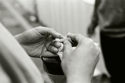 A man is rolling a cigarette.