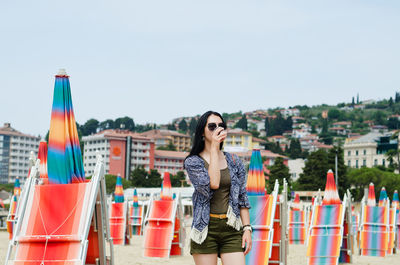 Lifestyle portrait. beautiful asian woman relaxing in sunny day at beach. summer. sea. travel