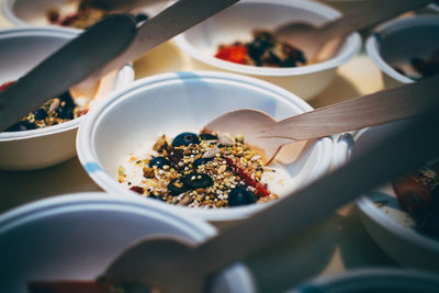 Close-up of fresh breakfast cereal served in bowls on table