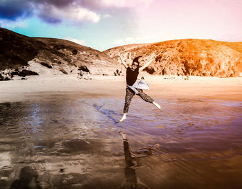 Man on snow covered land against sky