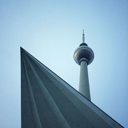 Low angle view of communications tower against sky