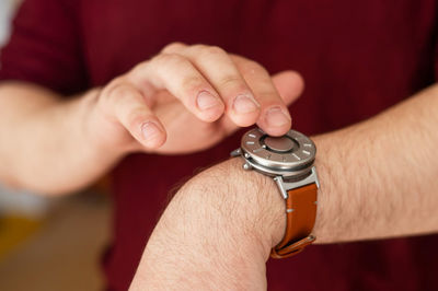 Cropped hand of man playing chess