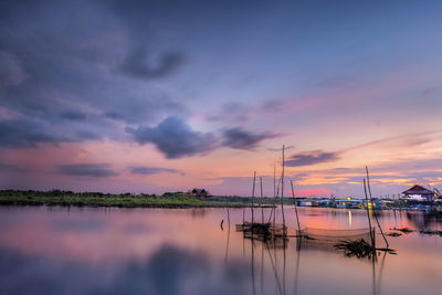 Sailboats in marina at sunset