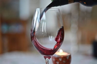Red wine pouring in glass