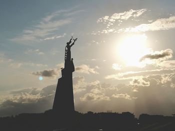 Low angle view of statue at sunset