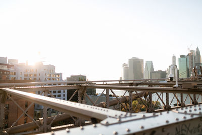 View of bridge and buildings against clear sky