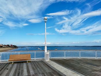 Pier over sea against blue sky