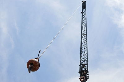 Low angle view of crane against sky