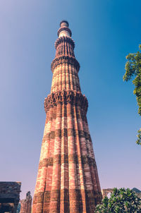 Low angle view of tower against blue sky
