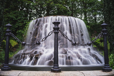 View of waterfall against trees