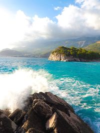 Scenic view of sea against cloudy sky
