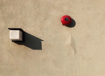 High angle view of red toy on wall