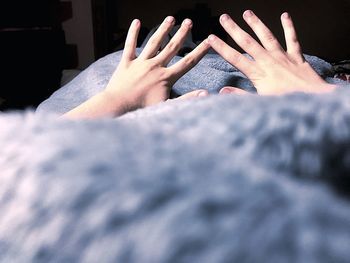 Cropped hands of person on blanket