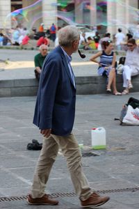 Rear view of people walking on street