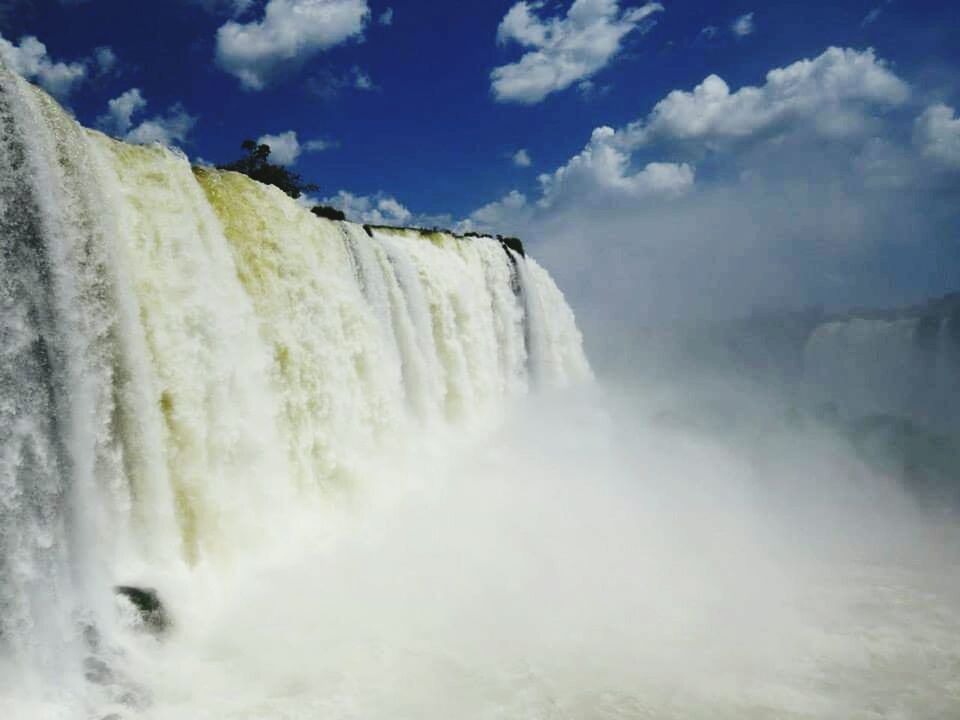 VIEW OF WATERFALL AGAINST SKY