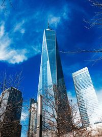 Low angle view of modern buildings against blue sky