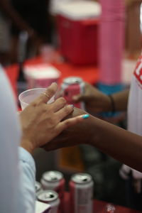 Close-up of hand holding ice cream in cafe