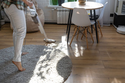 Low section of man standing on hardwood floor