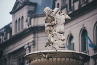 Low angle view of statue against building