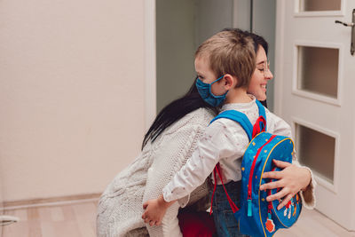 Mom and child getting ready to school with face mask for protection