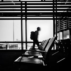 Silhouette man walking in airport