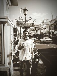 Portrait of smiling man standing in city