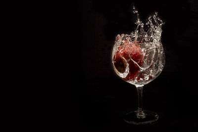 Close-up of wine glass against black background