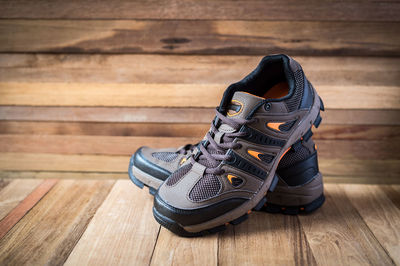 Close-up of hiking boots on wooden table