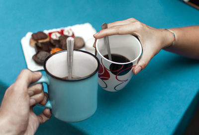 Midsection of woman holding coffee cup