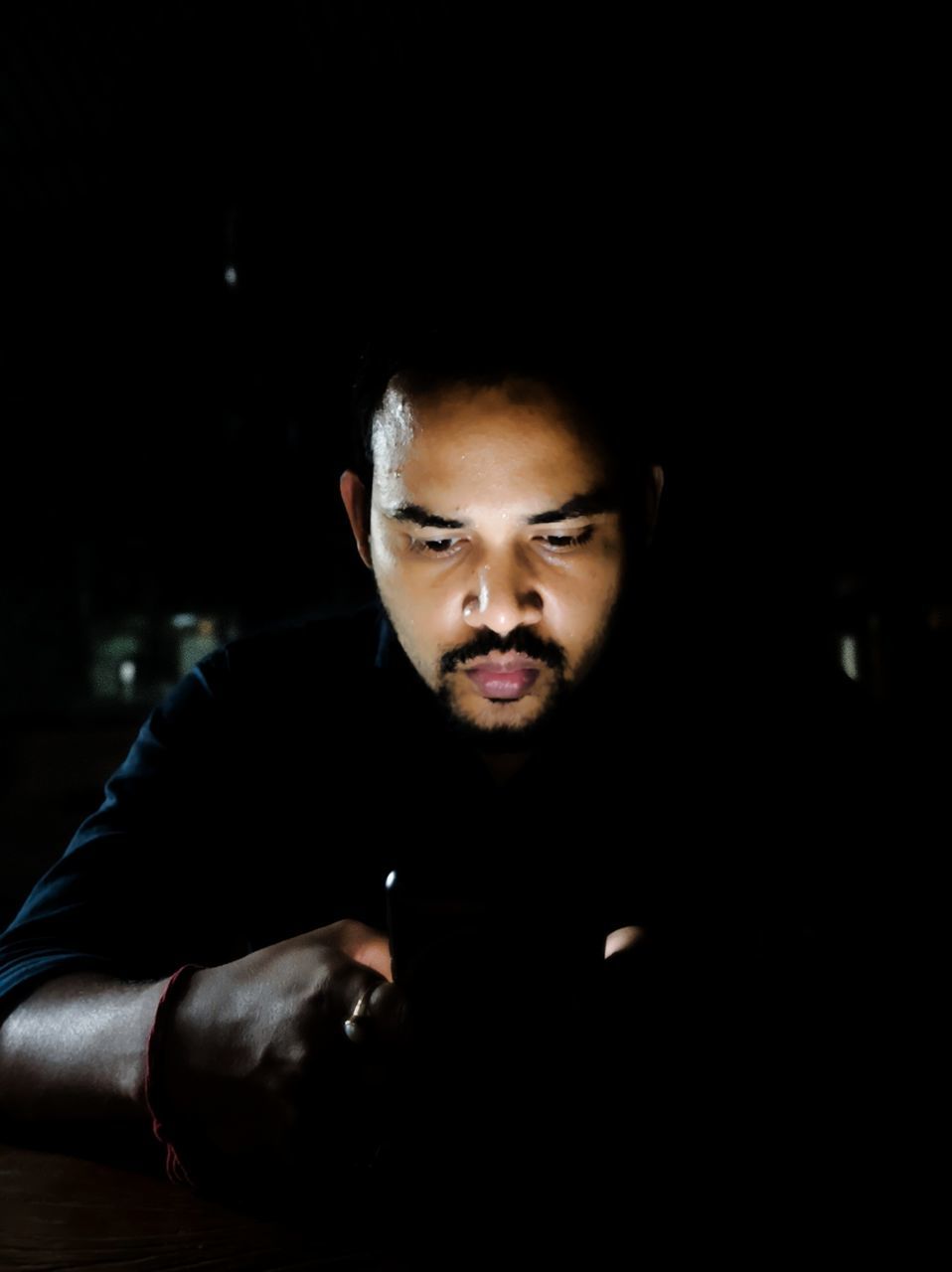 one person, darkness, portrait, adult, dark, indoors, young adult, front view, looking at camera, headshot, men, copy space, night, black, looking, serious, beard, lifestyles, facial hair, sitting