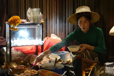 Young woman holding food on table